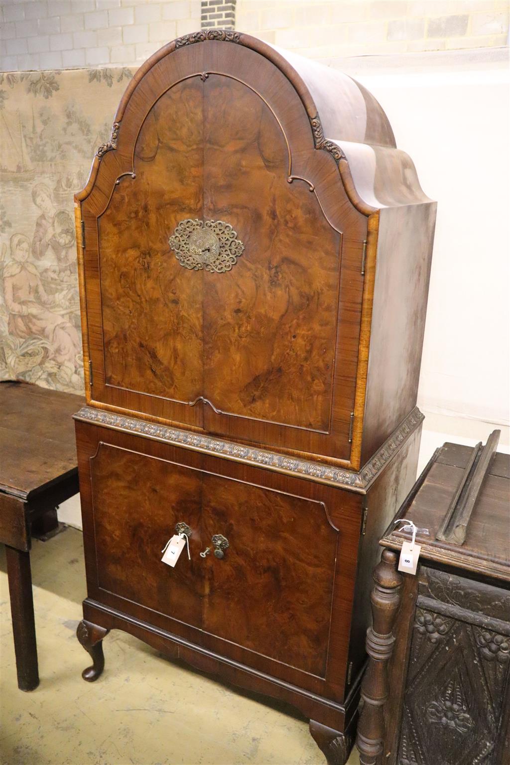 A burr walnut cocktail cabinet, width 81cm, depth 50cm, height 177cm with a collection of Tudor cut glassware